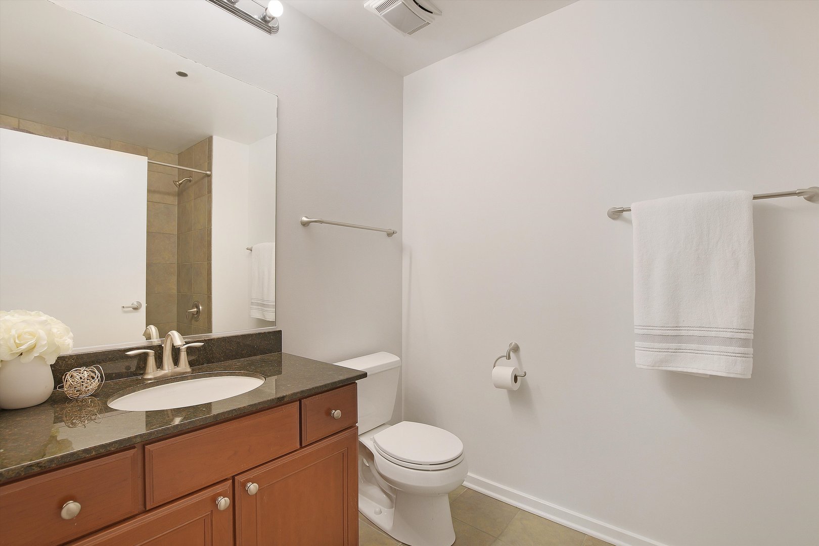 520 South State Street, Unit 510 Chicago, IL 60605 - Photo 23 of 34 a bathroom with a granite countertop sink toilet and a mirror