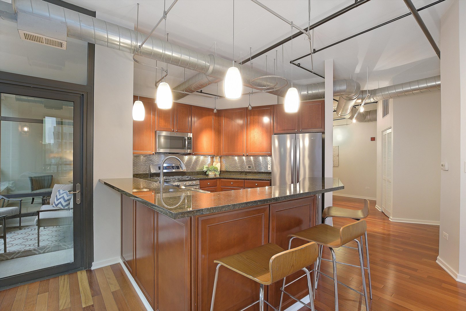 520 South State Street, Unit 510 Chicago, IL 60605 - Photo 5 of 34 a kitchen with stainless steel appliances granite countertop a sink and a refrigerator