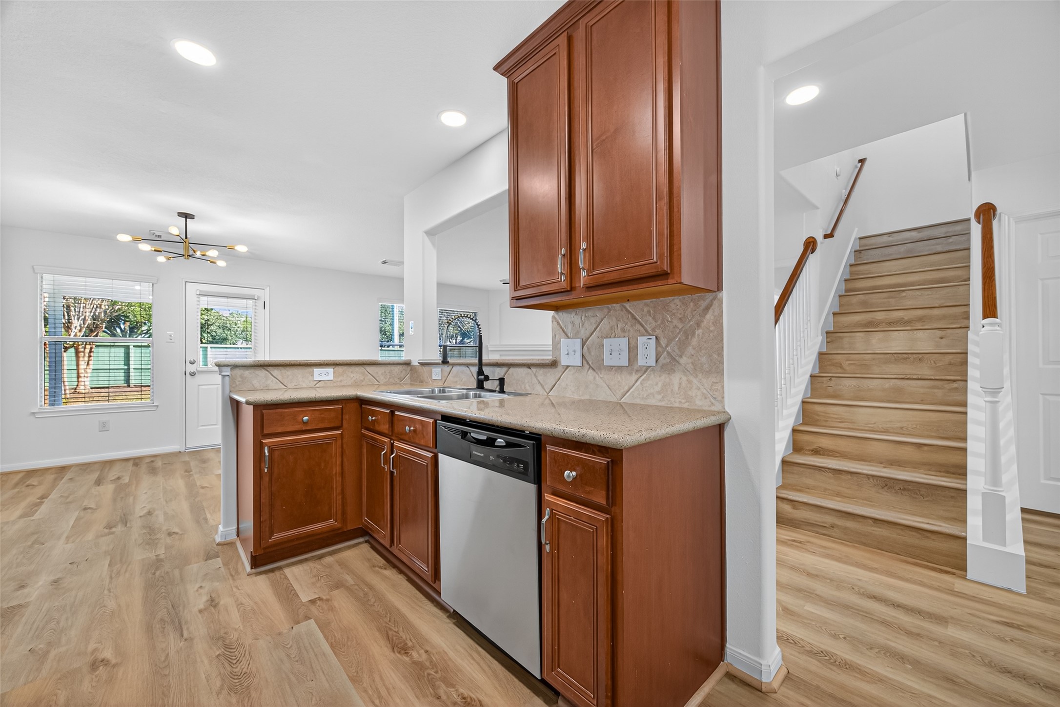 17422 Bending Post Drive Houston, TX 77095 - Photo 20 of 48 a kitchen with wooden cabinets and a sink