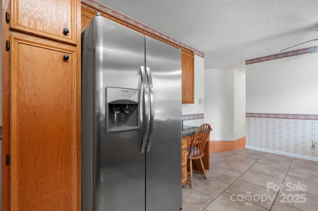 a metallic refrigerator freezer sitting in a kitchen