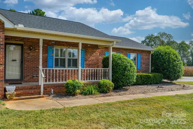 a view of a house with garden and pathway