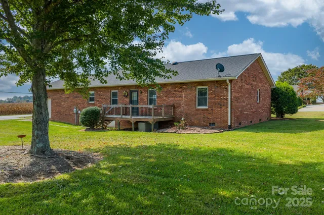an outdoor view of house with backyard and garden