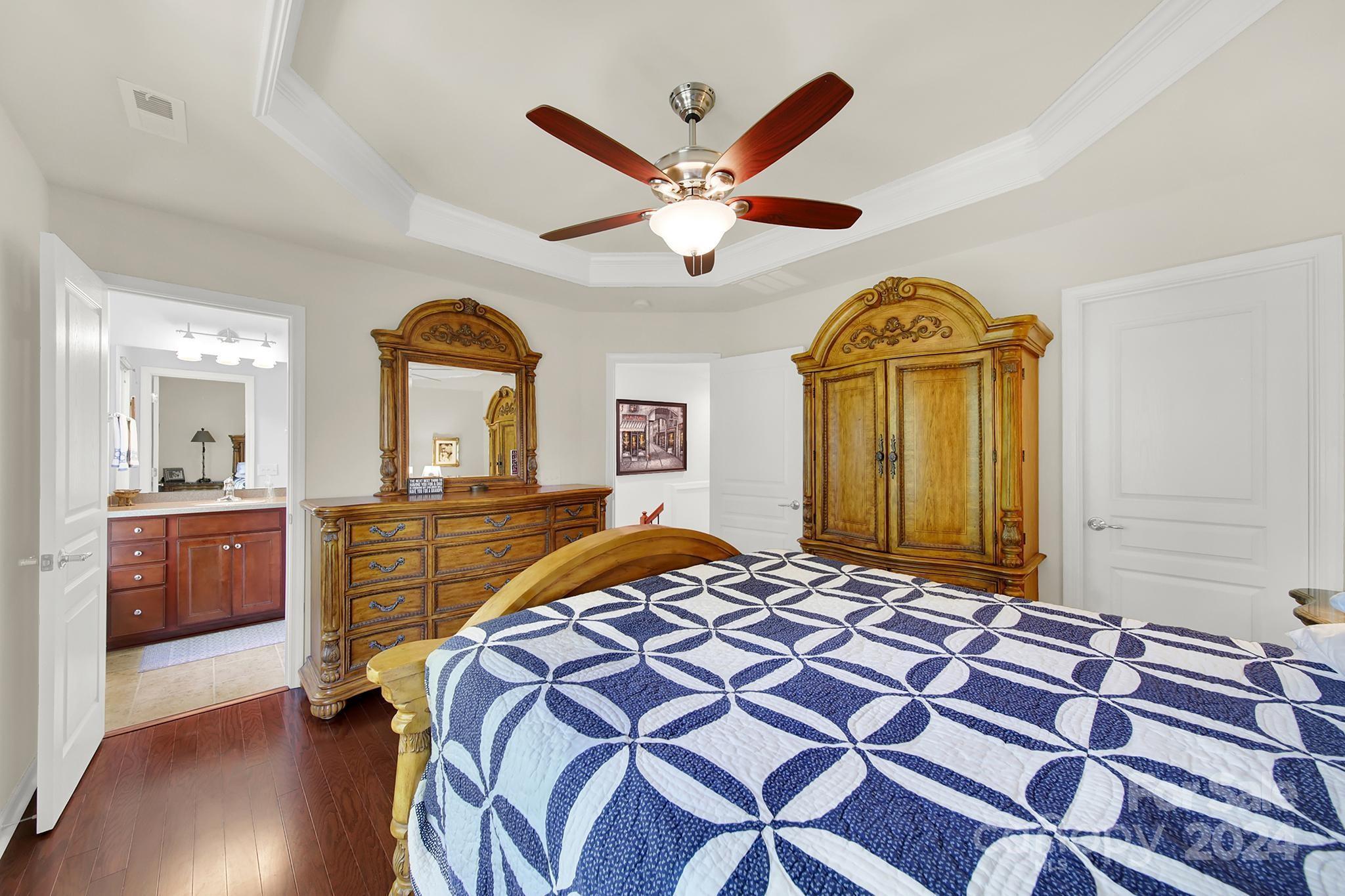 1074 Drayton Court Fort Mill, SC 29708 - Photo 18 of 37 a bedroom with a bed and a chandelier