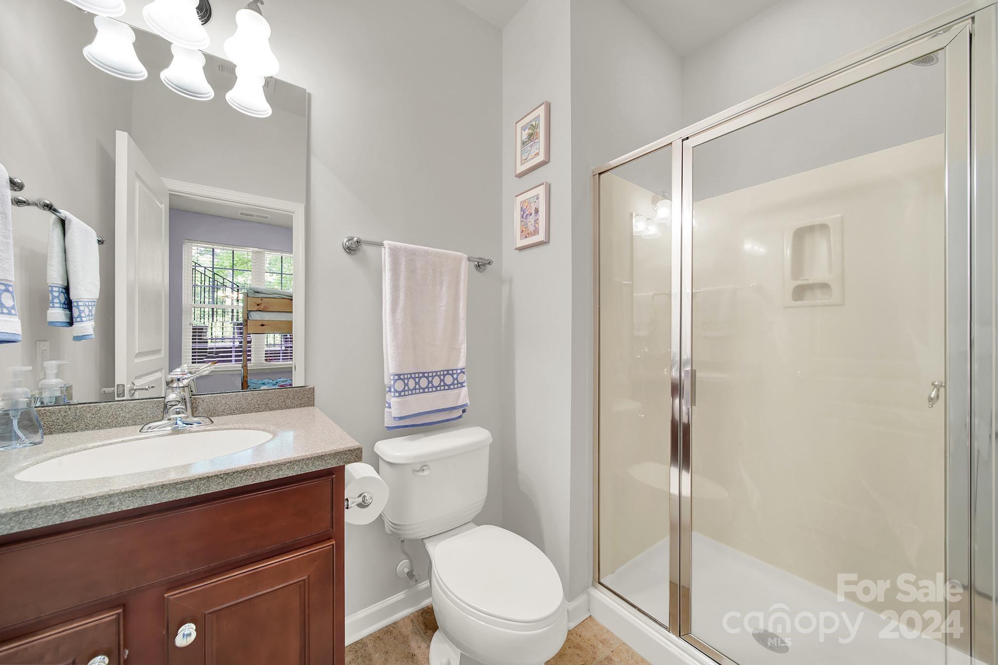 1074 Drayton Court Fort Mill, SC 29708 - Photo 27 of 37 a bathroom with a sink a toilet a mirror and shower