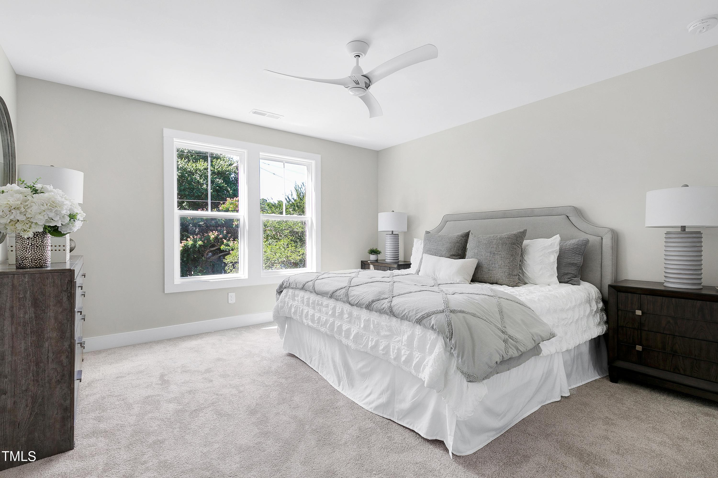 515 Raleigh Pines Drive, Unit 101 & 102 Raleigh, NC 27610 - Photo 17 of 27 a large bed sitting in a bedroom next to a window