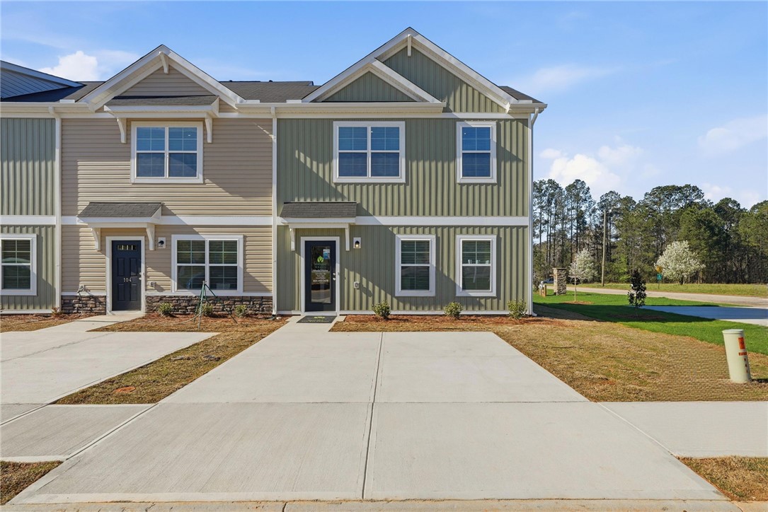 This charming townhome features inviting curb appeal with a well-maintained exterior and clear pathways.