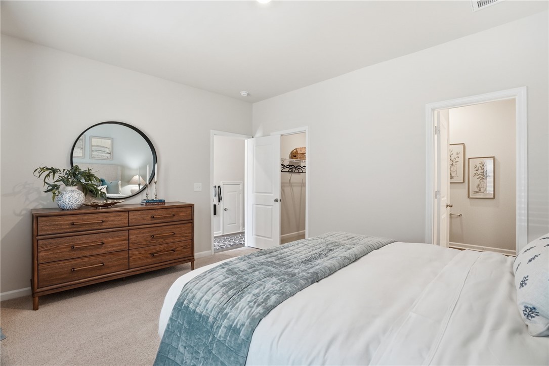 331 Lilac Loop Greenwood, SC 29646 - Photo 15 of 27 Bright and airy, this bedroom offers a calm retreat with ample space and thoughtful details.