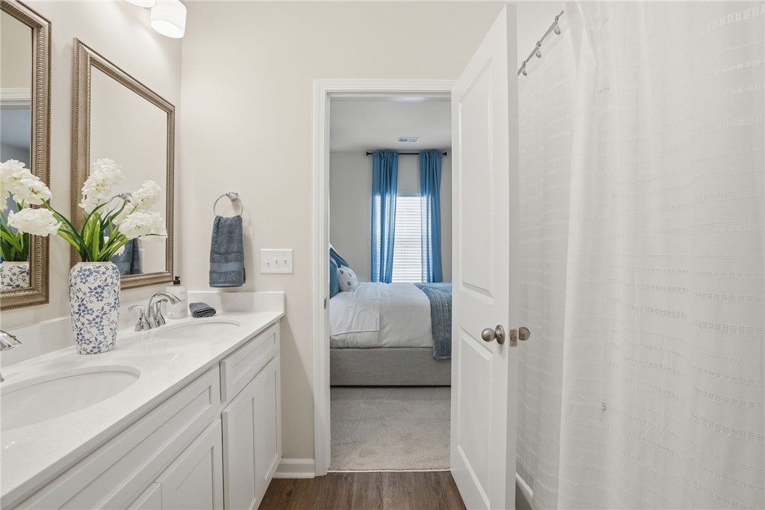 331 Lilac Loop Greenwood, SC 29646 - Photo 18 of 27 This bathroom offers a double vanity and sleek countertops, providing ample space and style.