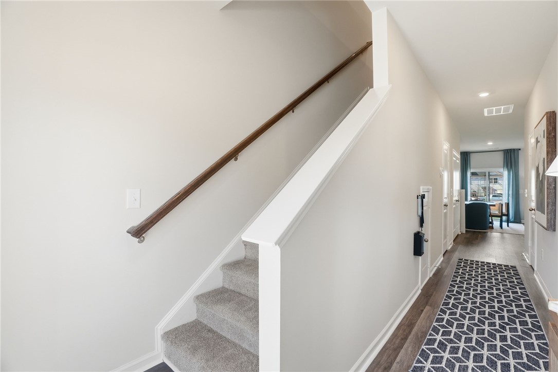 331 Lilac Loop Greenwood, SC 29646 - Photo 2 of 27 This interior captures a well-lit hallway leading to a bright living area, offering a glimpse into comfort.