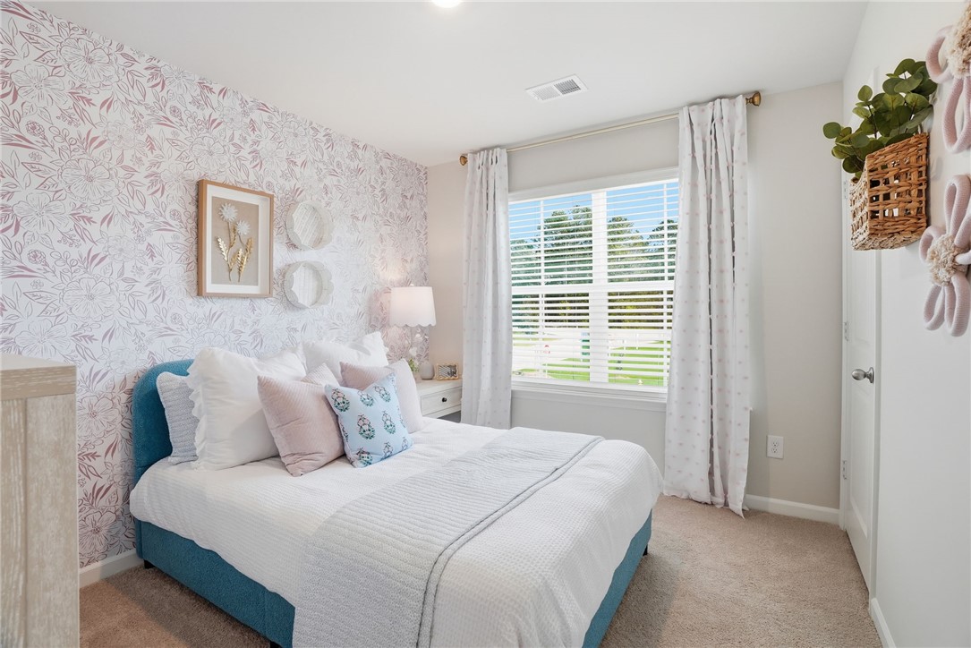 331 Lilac Loop Greenwood, SC 29646 - Photo 22 of 27 This cozy bedroom offers a peaceful retreat with ample natural light.
