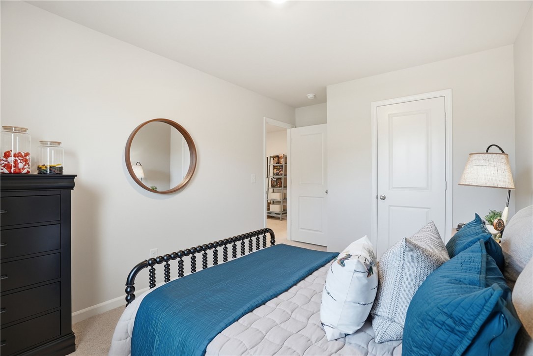 331 Lilac Loop Greenwood, SC 29646 - Photo 26 of 27 This cozy bedroom offers a tranquil retreat with soft lighting and a calming color palette.