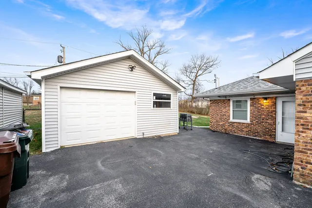 a view of a house with a yard and garage