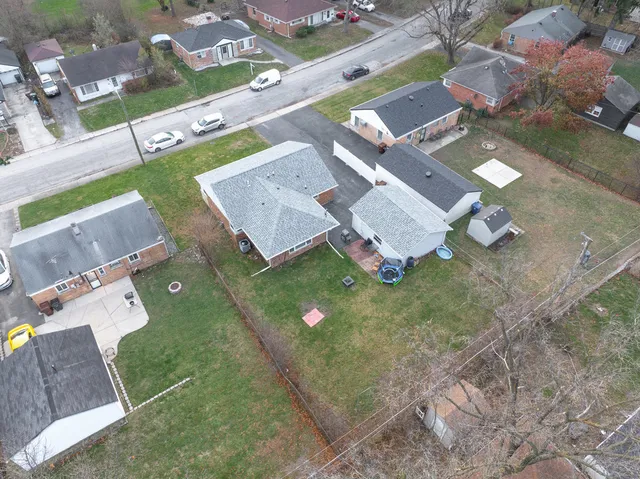 an aerial view of a house with garden space and street view