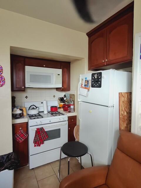 205 West Lancaster Boulevard Lancaster, CA 93534 - Photo 8 of 12 a kitchen with stainless steel appliances granite countertop a refrigerator sink and cabinets