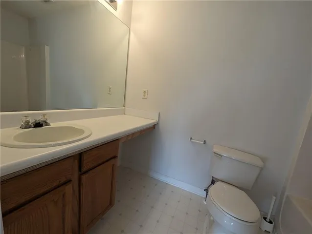 a bathroom with a sink toilet and a mirror