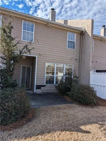 a view of a house with brick walls and a yard
