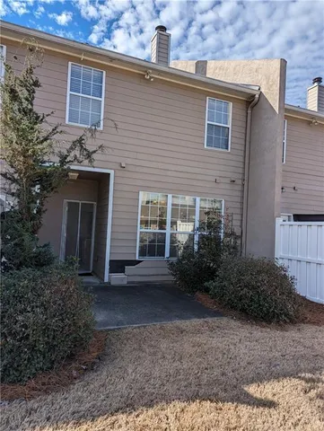a view of a house with brick walls and a yard