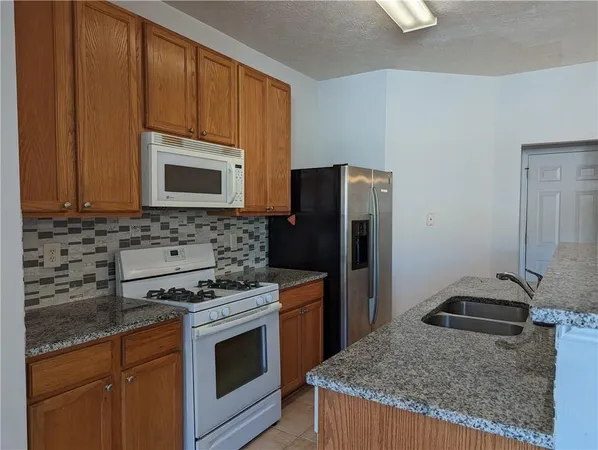 a kitchen with a stove microwave and refrigerator