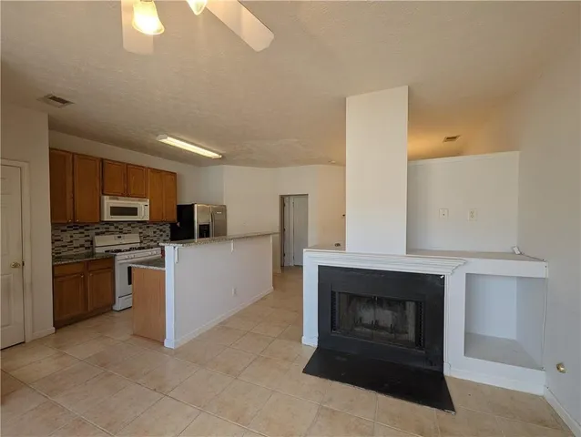 a kitchen with a stove and white cabinets