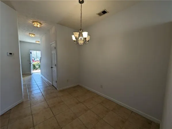 a view of a chandelier in big room and chandelier fan