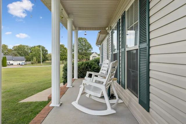 a view of a patio with a table chairs and garden