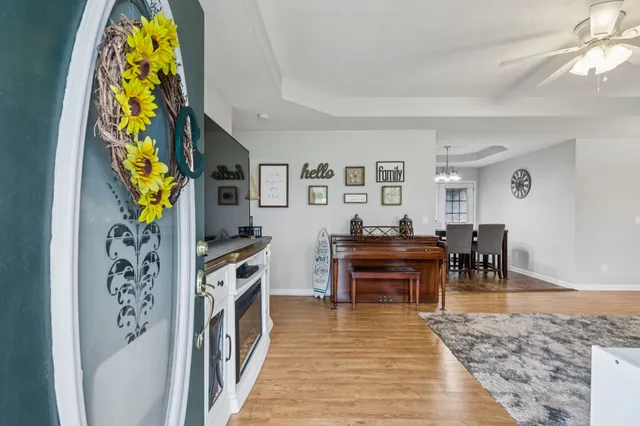 a living room with furniture and a wooden floor