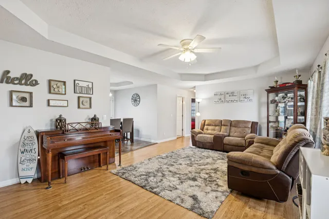 a living room with furniture or couch and a piano
