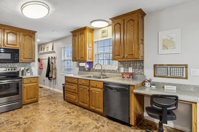 a kitchen with a sink appliances and cabinets
