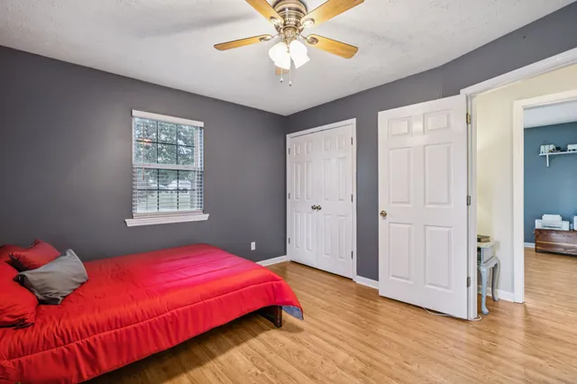 a bedroom with a bed and a chandelier