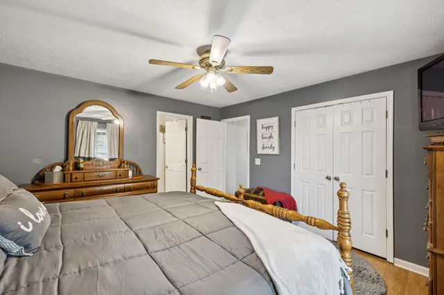 a bedroom with a bed and a chandelier