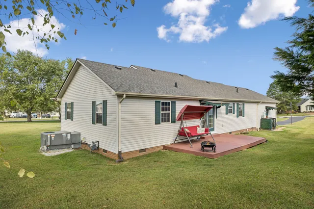 a car parked in front of house with a yard