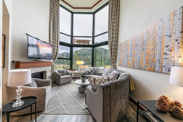 a living room with furniture and a floor to ceiling window