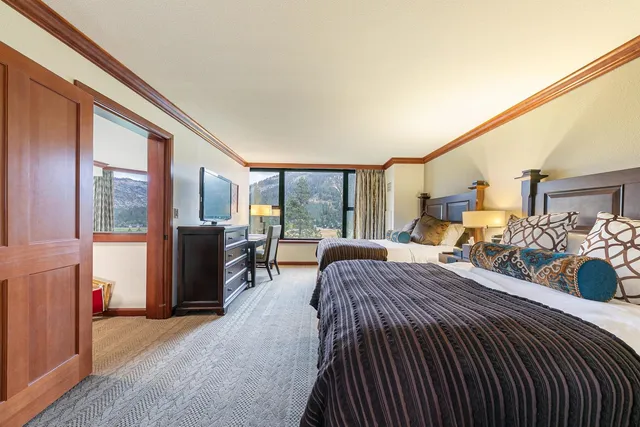 a bedroom with bed and glass door