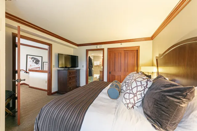 a bedroom with a bed and a television