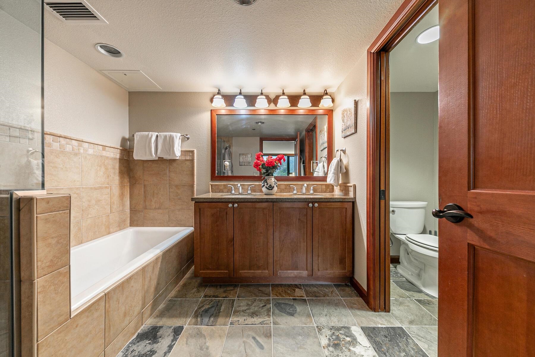 400 Resort Road, Unit 822 824 Olympic Valley, CA 96146 - Photo 21 of 28 a bathroom with a tub a sink and a mirror