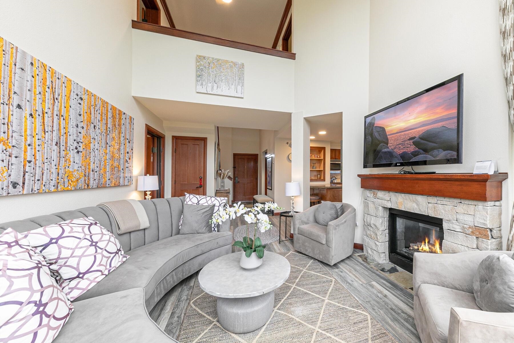 400 Resort Road, Unit 822 824 Olympic Valley, CA 96146 - Photo 4 of 28 a living room with furniture a flat screen tv and a fireplace