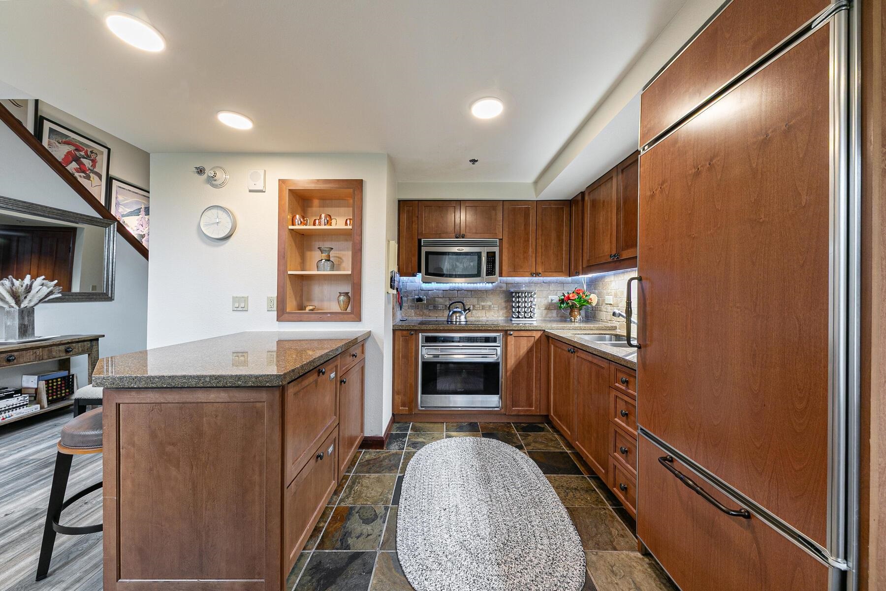 400 Resort Road, Unit 822 824 Olympic Valley, CA 96146 - Photo 9 of 28 a kitchen with granite countertop a stove top oven sink and cabinets