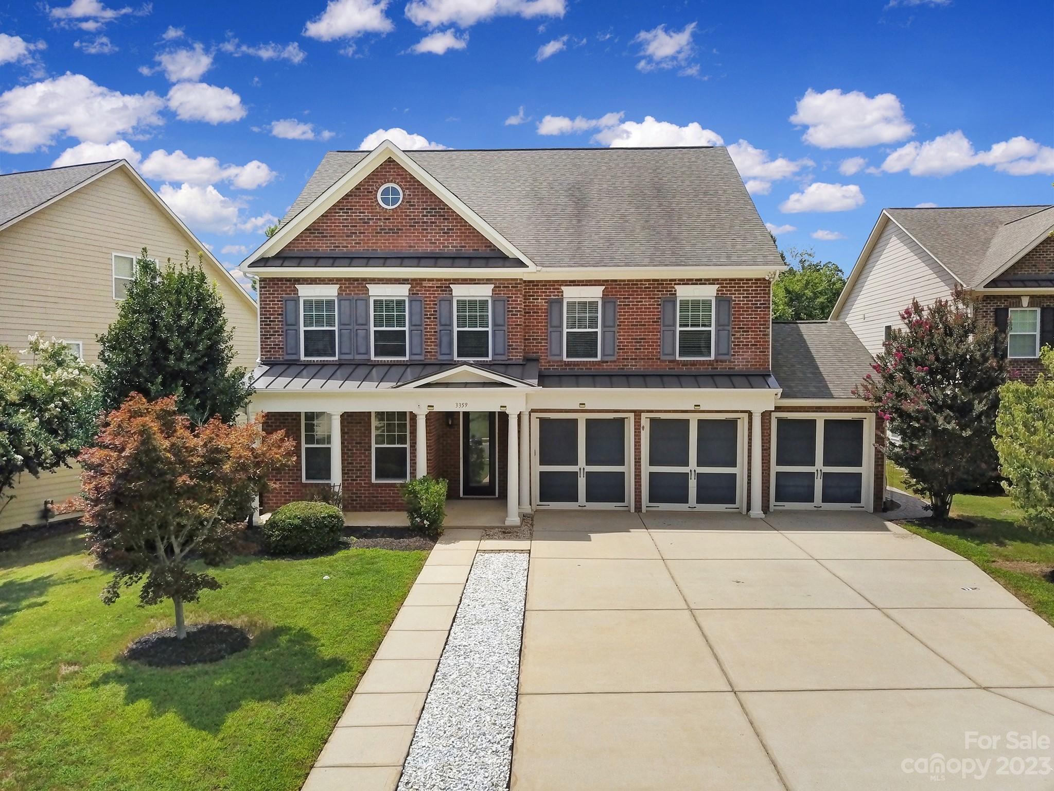 3359 Mandrake Court Tega Cay, SC 29708 - Photo 2 of 33 a front view of a house with a yard and potted plants
