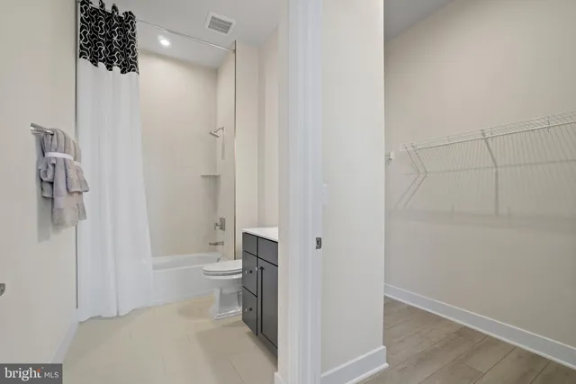 a bathroom with a toilet and a shower