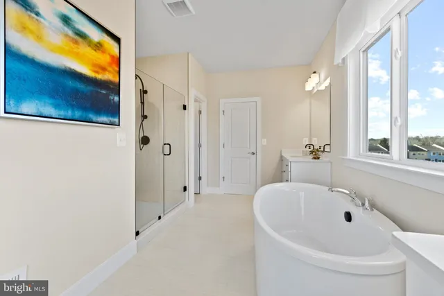 a white bath tub sitting next to a window