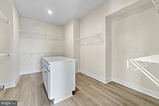 a utility room with wooden floor washer and dryer