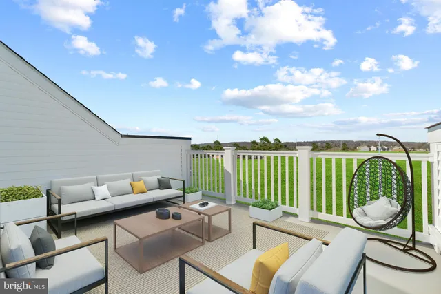 a roof deck with couches and pool