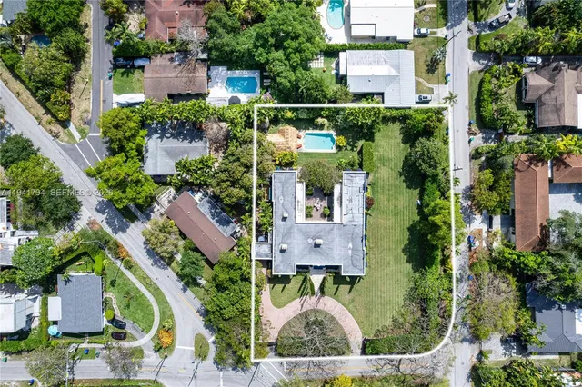 an aerial view of residential houses with outdoor space and street view