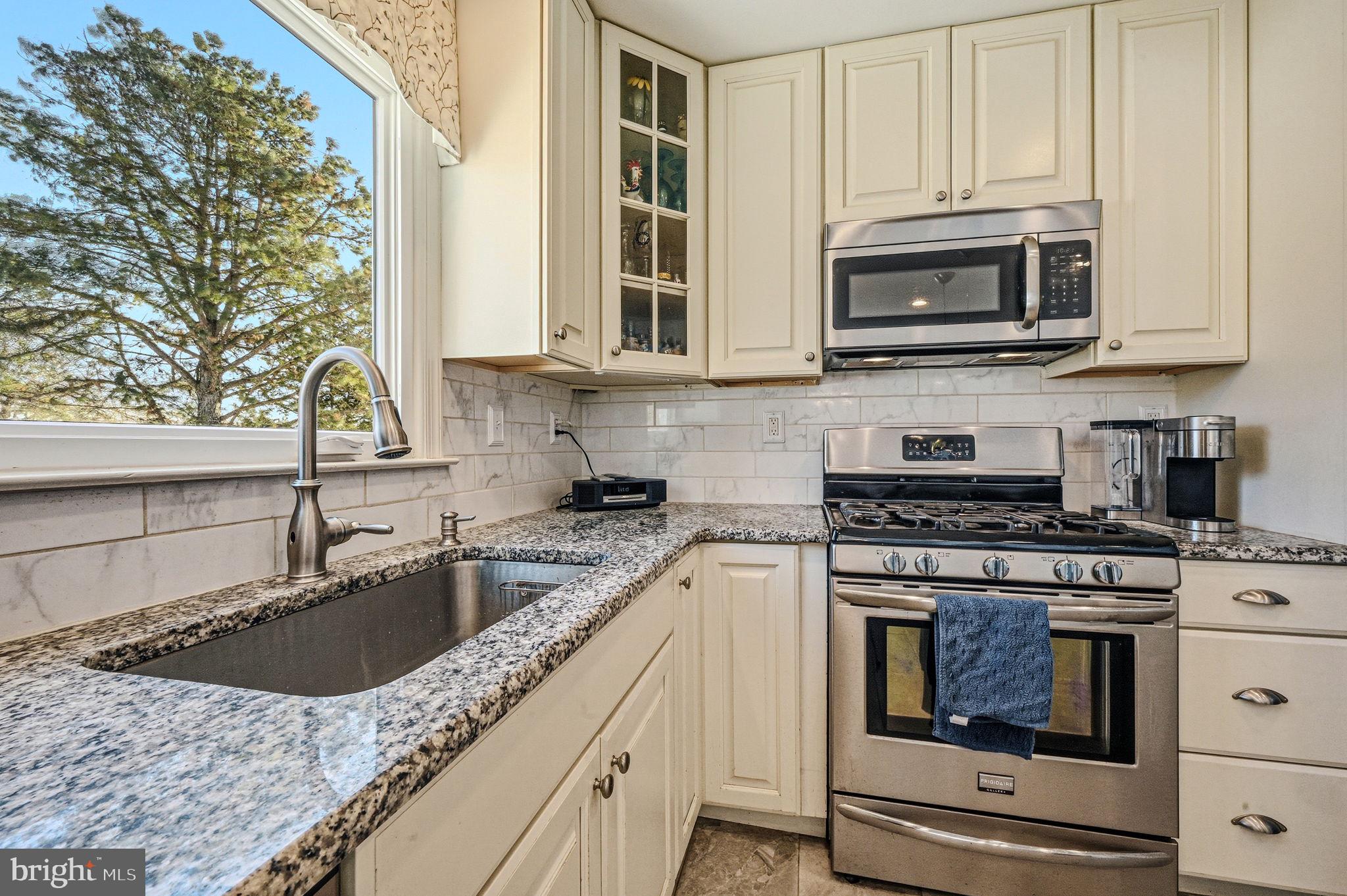 10 Auspice Circle Newark, DE 19711 - Photo 15 of 42 a kitchen with stainless steel appliances granite countertop a stove a sink and a microwave