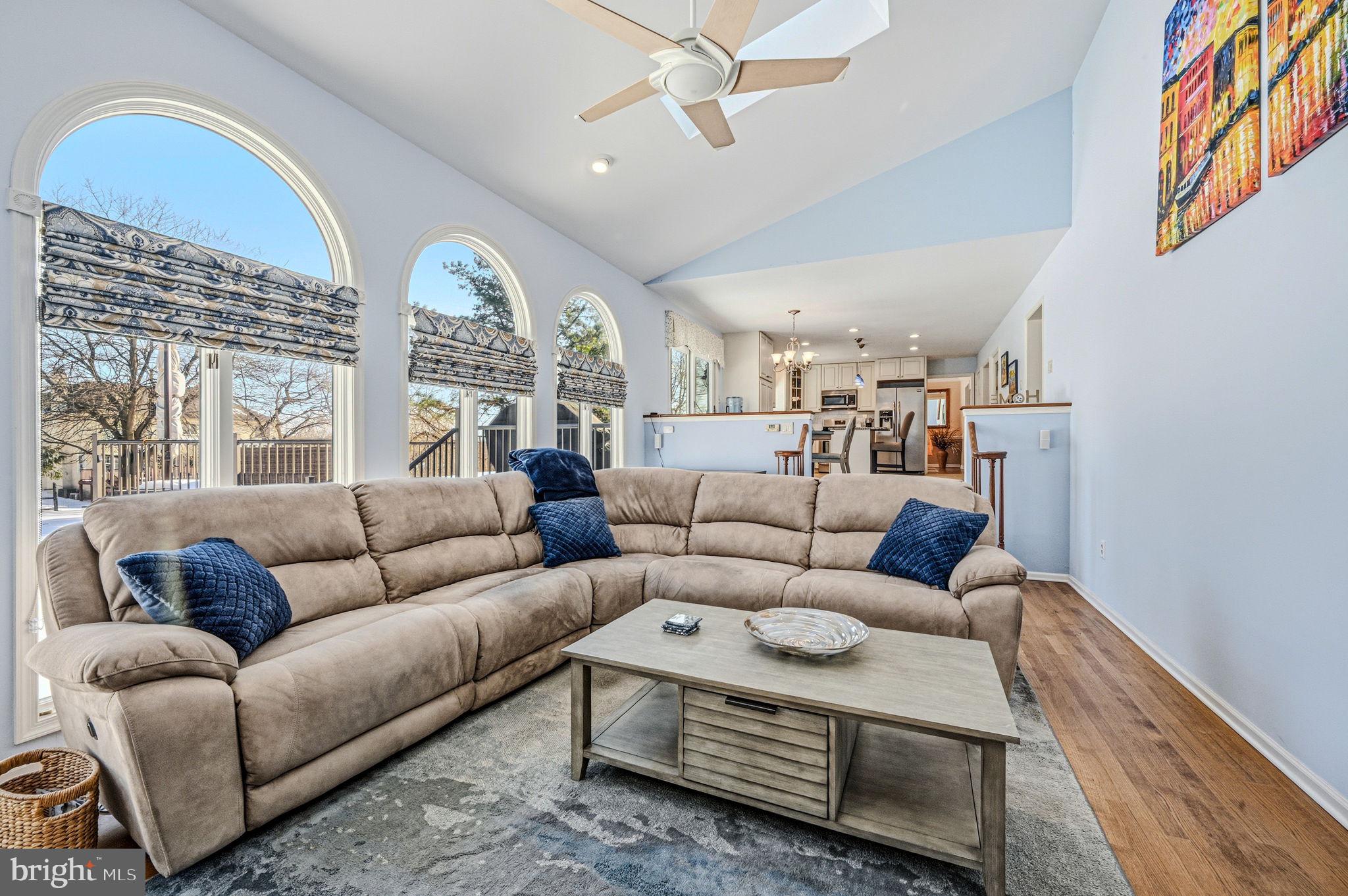 10 Auspice Circle Newark, DE 19711 - Photo 20 of 42 a living room with furniture a chandelier and a large window
