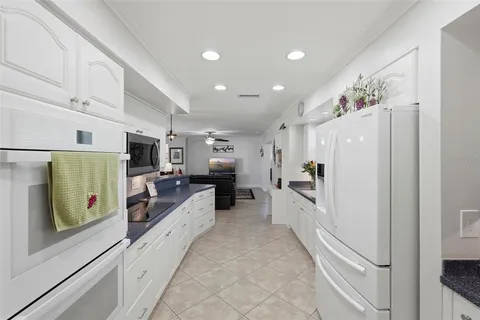 a large white kitchen with stainless steel appliances