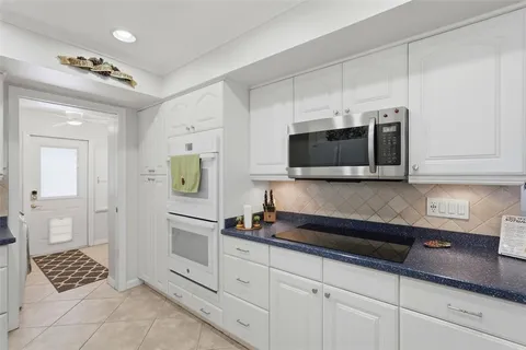 a kitchen with stainless steel appliances a sink stove and cabinets