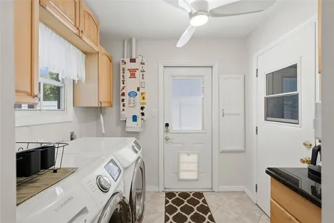 a kitchen with granite countertop a sink a stove and a microwave oven