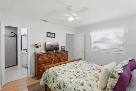 a bedroom with a bed and a flat screen tv
