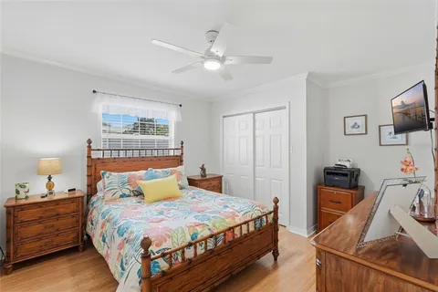 a bedroom with a bed and wooden floor